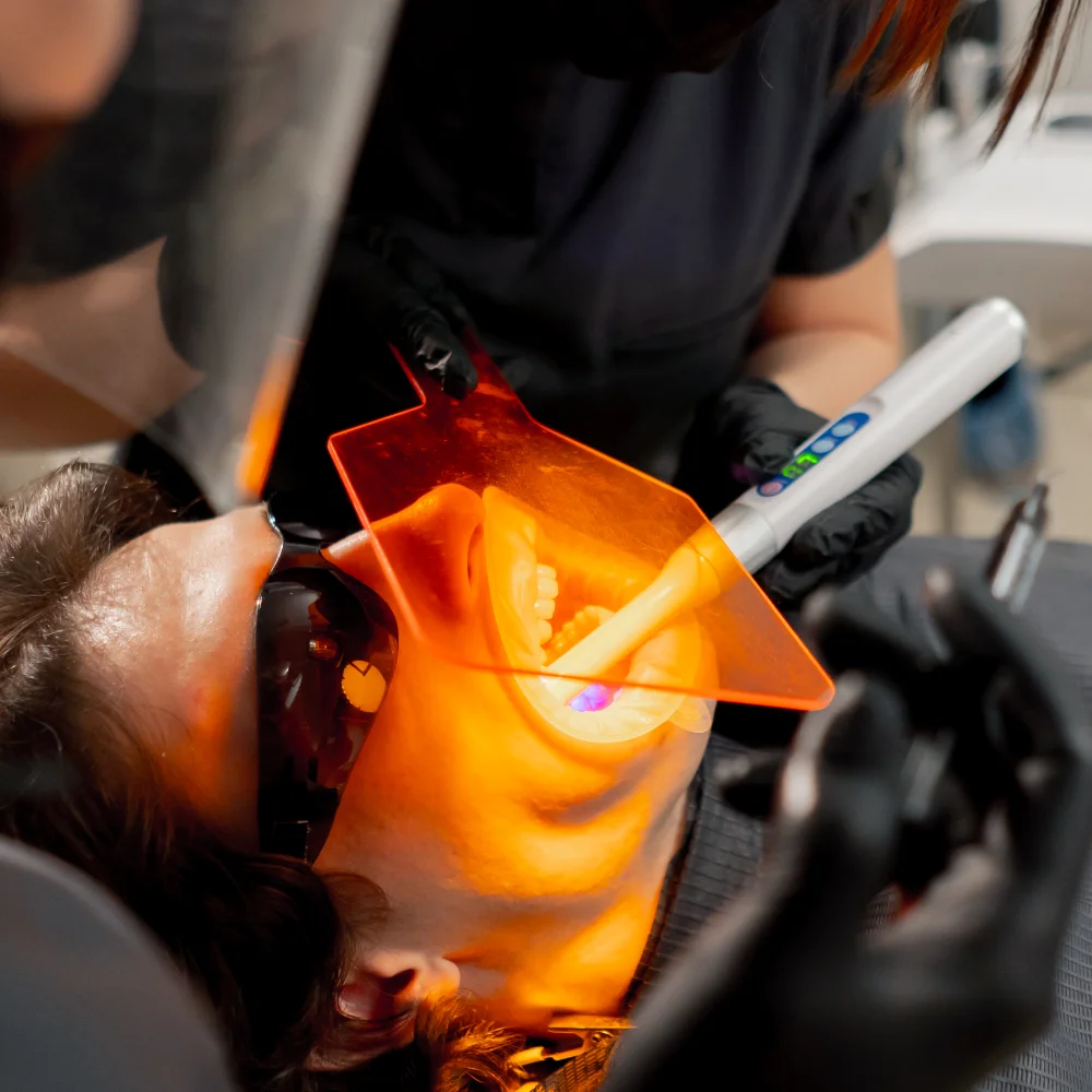 dental-office-girl-dentist-applies-protective-gel-K9L3GF9.webp